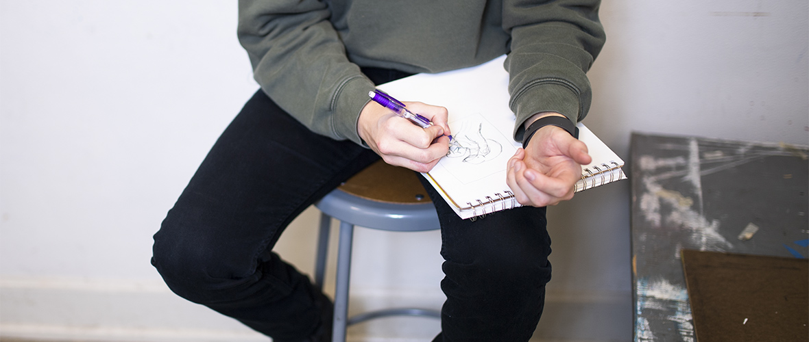 Student drawing their own hand